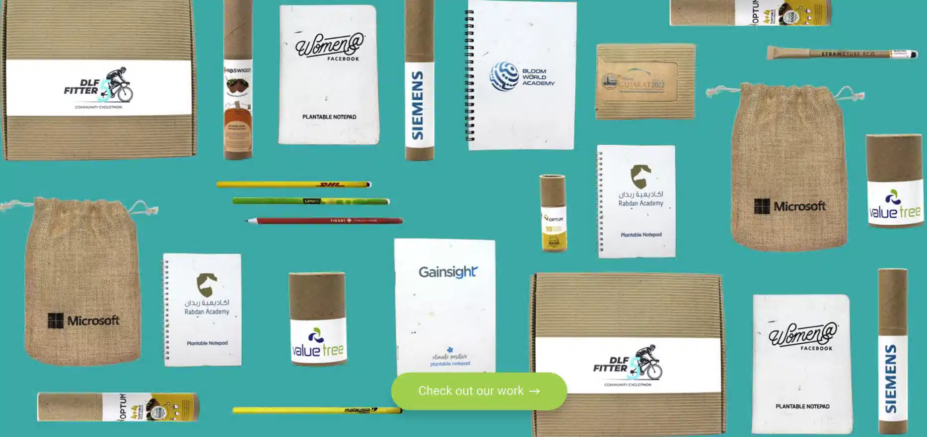 bioQ eco corporate gifting flatlay with notebooks, boxes, paper tubes and desk accessories arranged as a considered shortlist